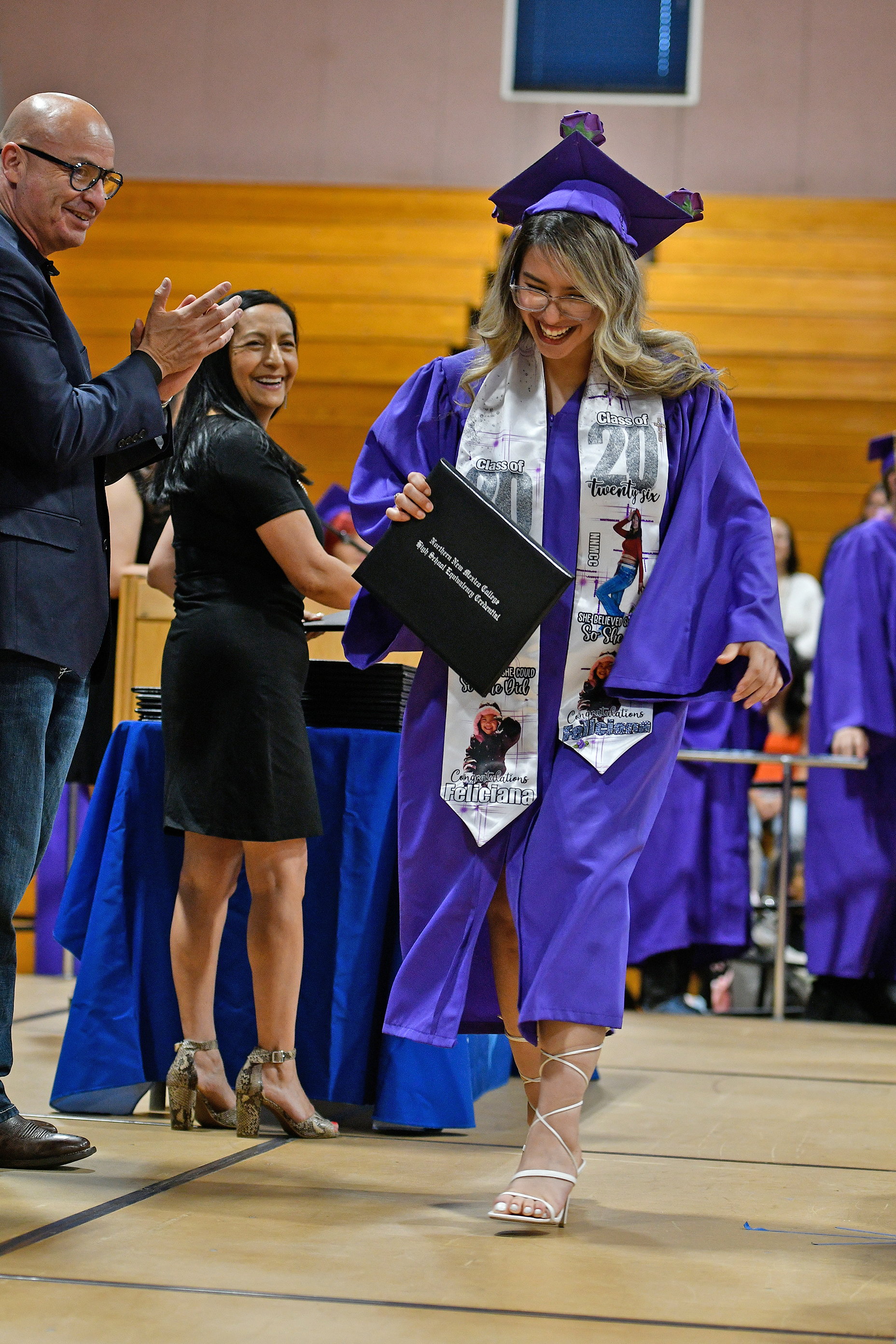 President Baldreas and Cecilia Romero smiling at a graduate